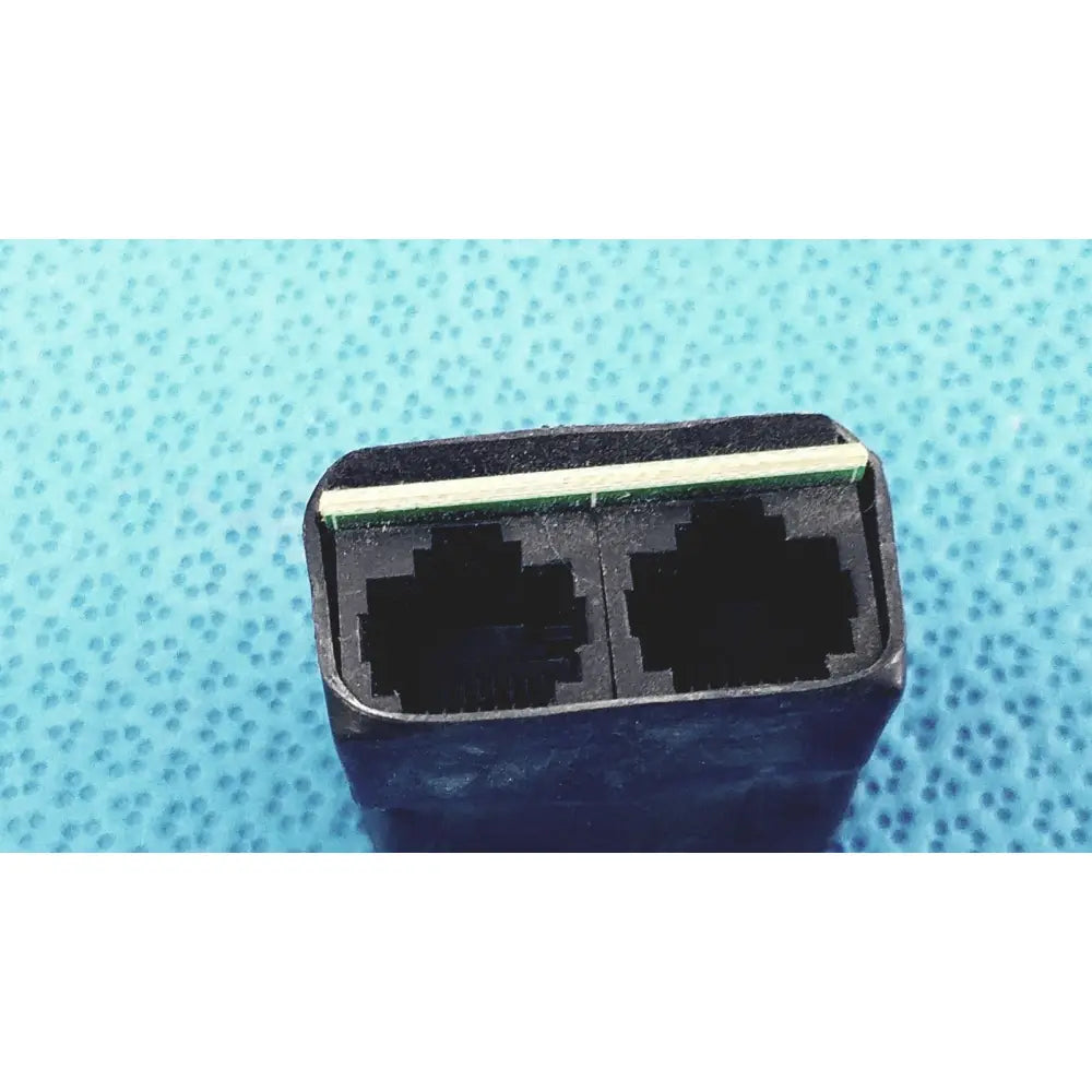 Black plastic 2-port female breakout adapter with two rj45 ethernet ports and green stripe for usb-a connection