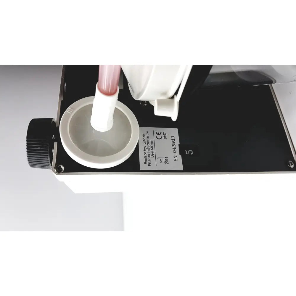 White plastic filter housing with pink-tinted liquid tube inserted in precision medical easy go vac aspirator bottle