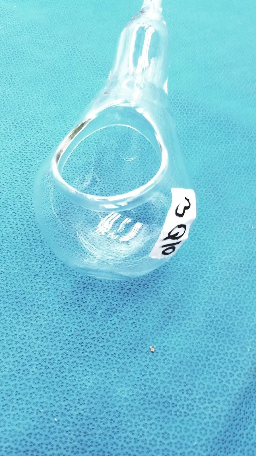 Clear glass 24/40 glassware adapter with white label connecting a 90° cone to rubber hose tube inlet joint