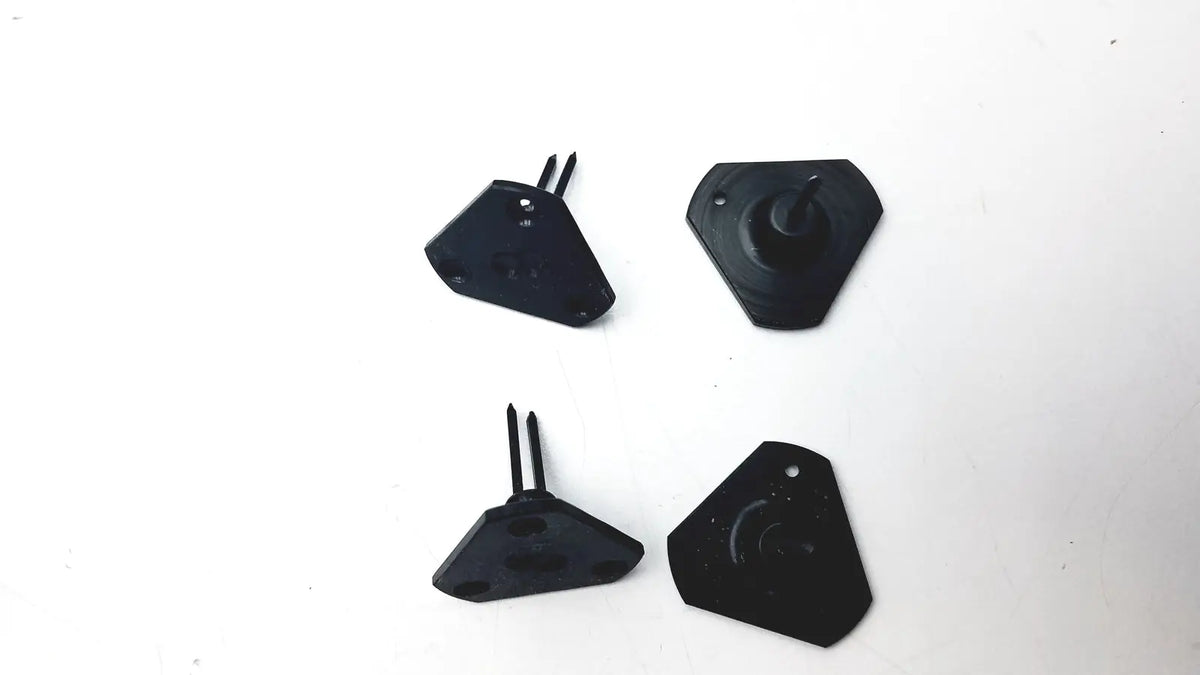 Black plastic car air vent covers with dual prongs and central hole for mounting in calibration kit a1146001b