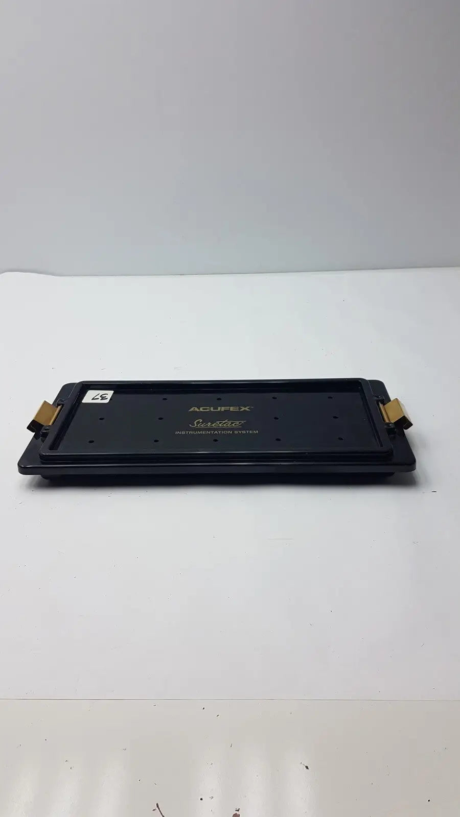 Black acupex saddlefit pro illumination system tray with gold-colored side clips for acufex suretac instrument use