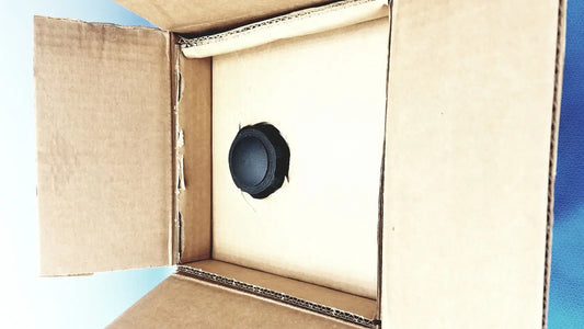Black circular speaker driver inside cardboard box for adroit htp-1500 heat therapy pump heat therapy device