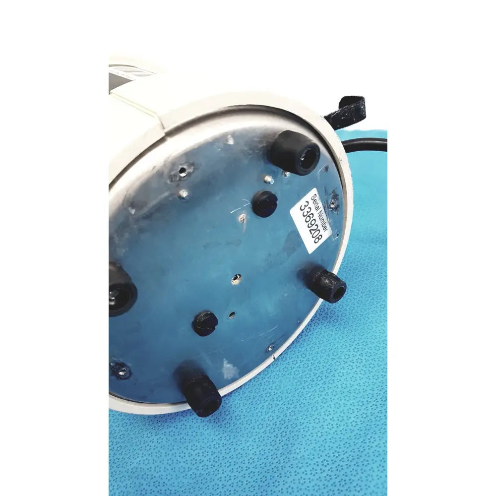 White circular adroit htp-1500 heat therapy pump with blue metallic base and serial number on underside for portable hot cold use
