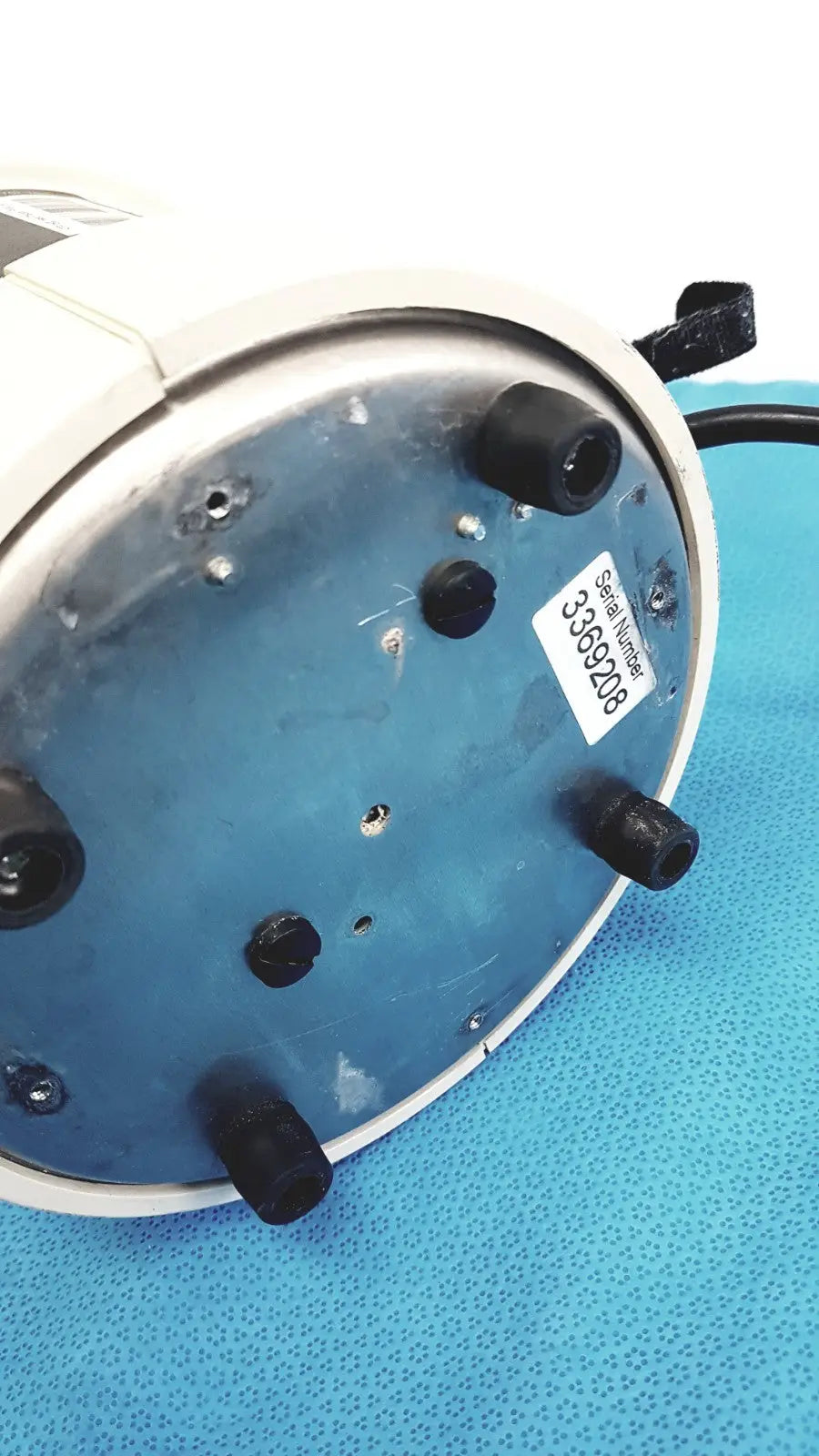 White circular adroit htp-1500 heat therapy pump with blue metallic base and serial number on underside for portable hot cold use