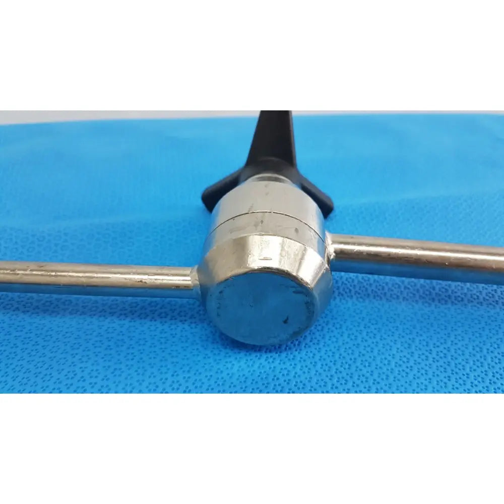 Silver surgical retractor with black ergonomic handle and two metallic rods part of aesculap ff168r u-shaped arm system