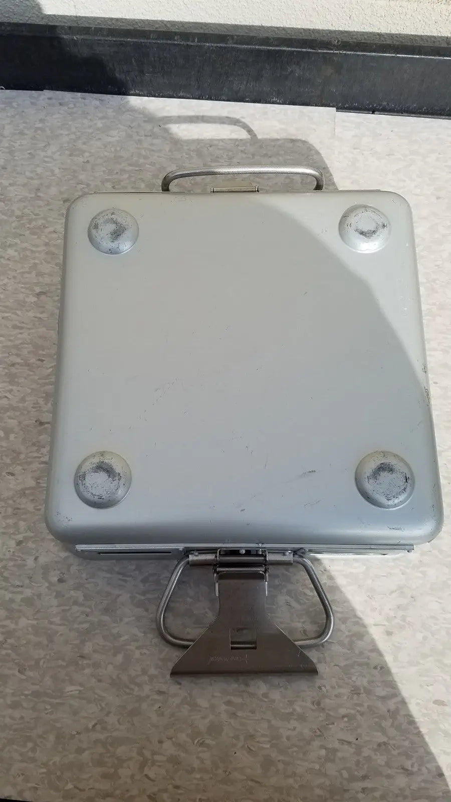 Silver metallic aesculap sterilization container without lid featuring sturdy handle and four corner reinforcements