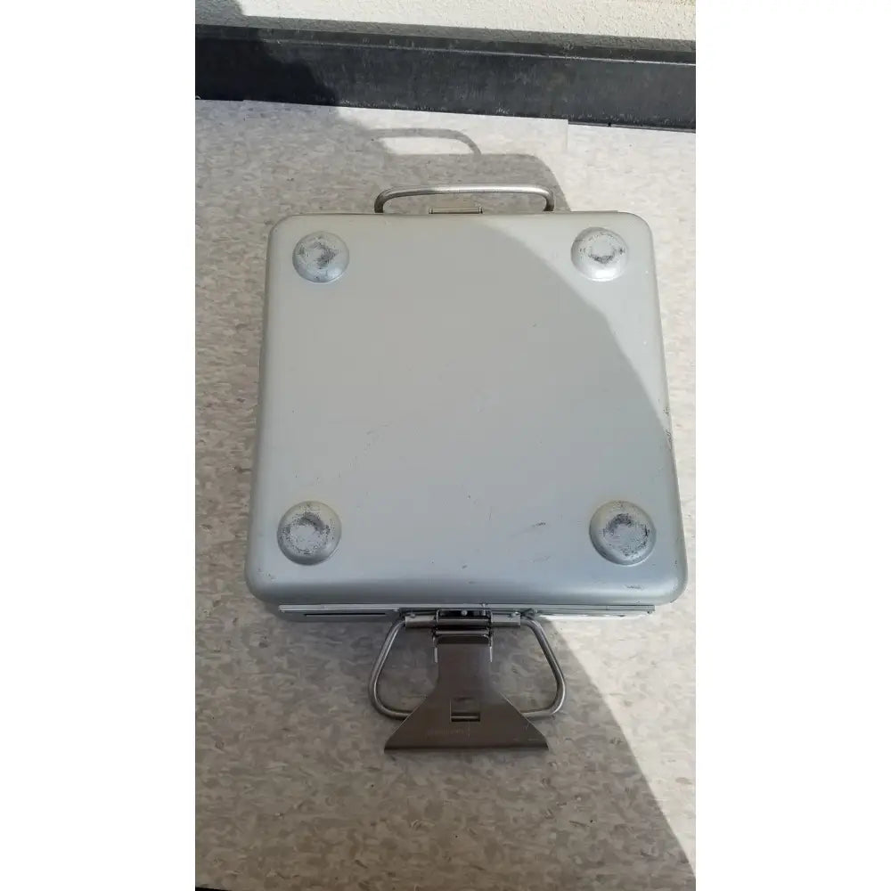 Silver metallic aesculap sterilization container without lid featuring sturdy handle and four corner reinforcements