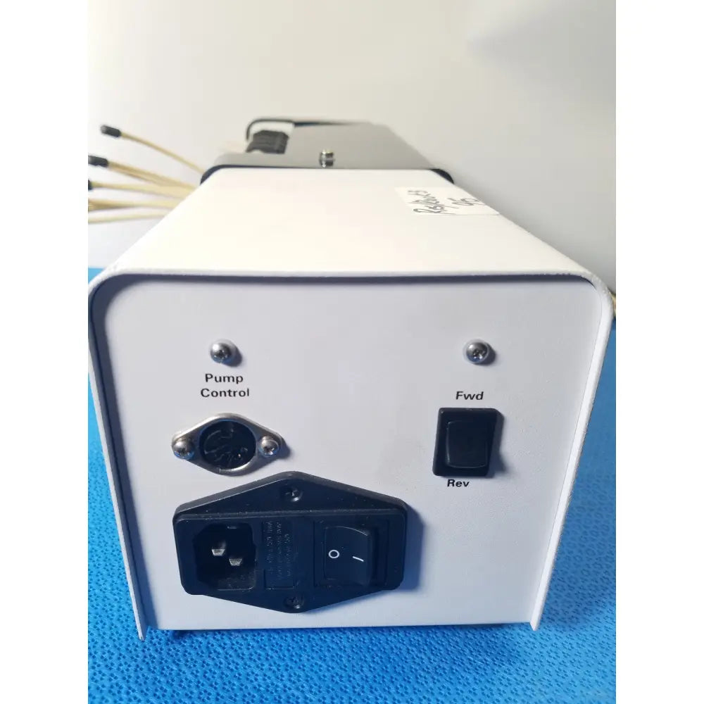 White rectangular agilent technologies 810 peristaltic pump control unit with toggle switches for reuse medical applications