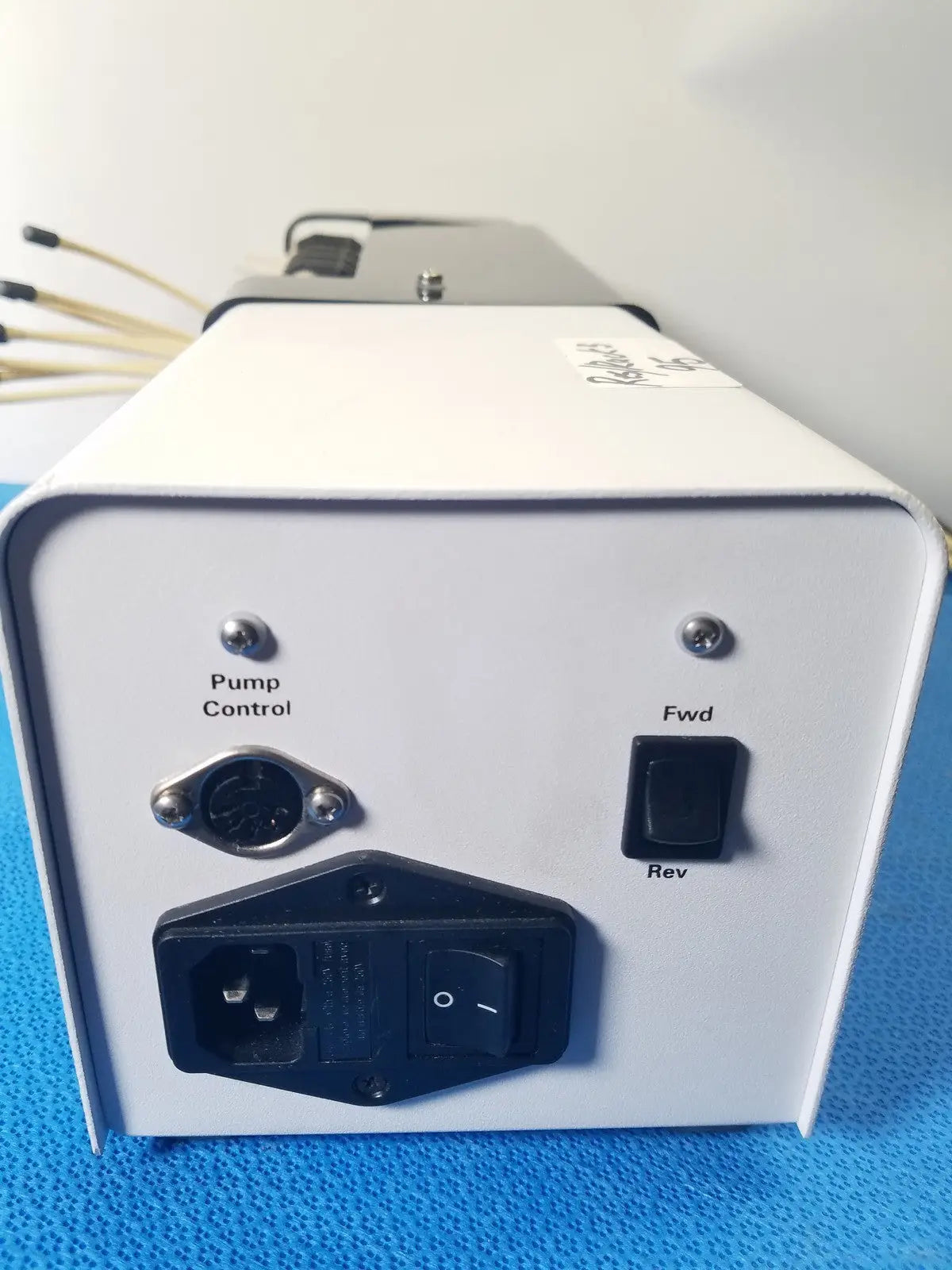 White rectangular agilent technologies 810 peristaltic pump control unit with toggle switches for reuse medical applications