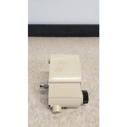 Cream-colored plastic airco vacuum regulator with black knob and metallic fittings for precise airco vacuum control