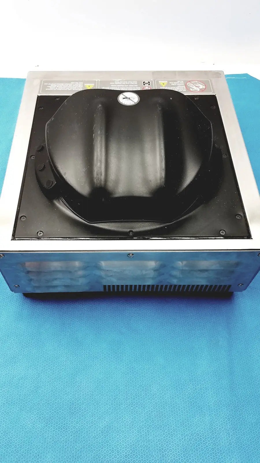 Black plastic dome-shaped lid with emblem on metallic frame of aladdin temp-rite heat on demand advantage plate heater