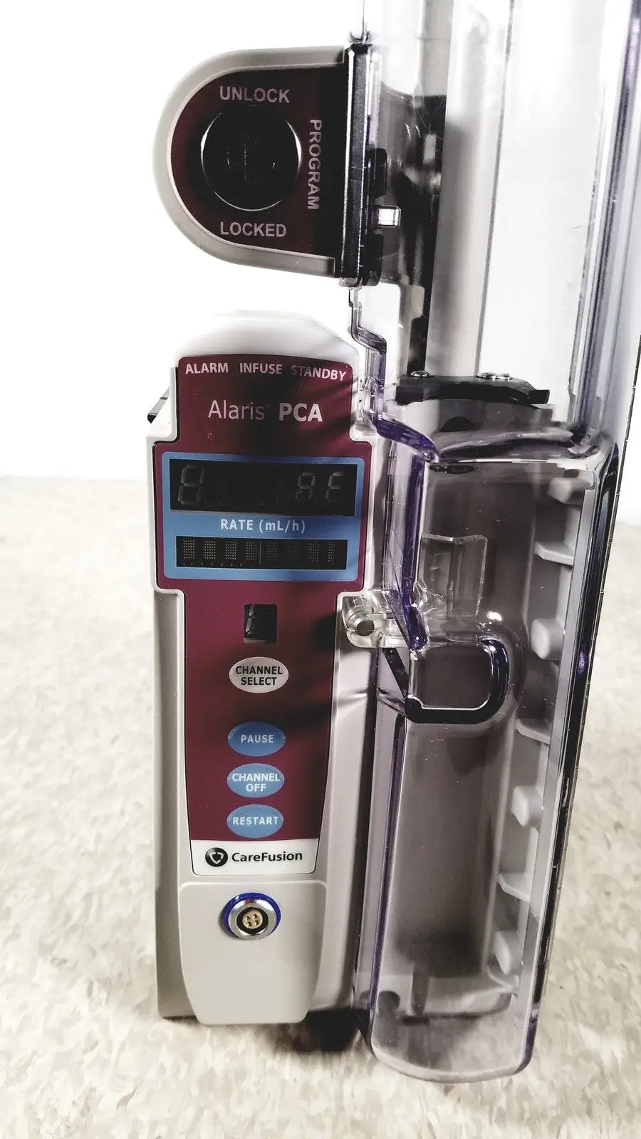 Maroon and silver alariis pca model 8120 infusion pump with transparent medication bag attached without keys