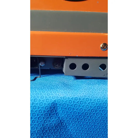 Orange and gray industrial alcatel drytel 31 vacuum pump station with metallic screw head as key feature