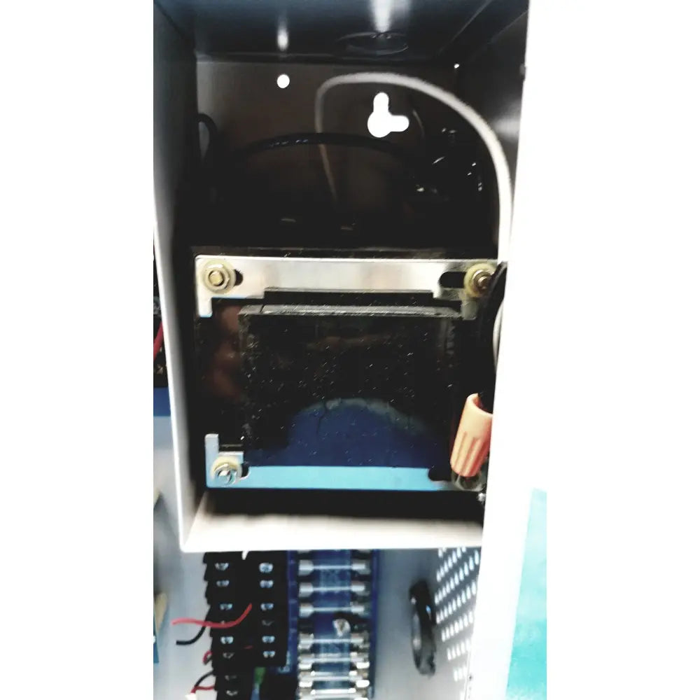Black rectangular altronix smp5ctx high current power supply with metallic brackets and wiring inside white enclosure