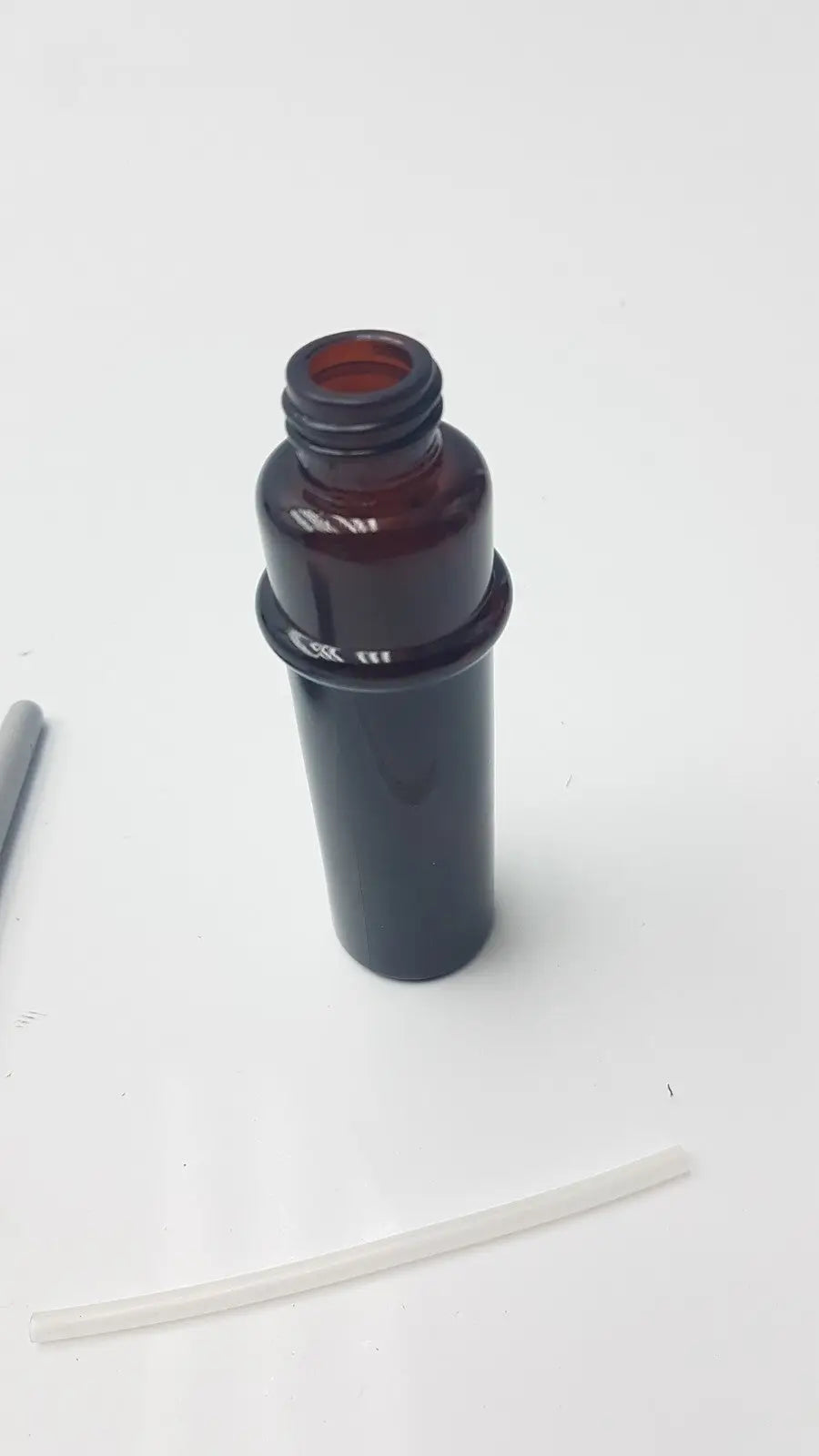 Dark amber glass plastic mist bottle with threaded neck and black plastic cap for amber plastic mist use