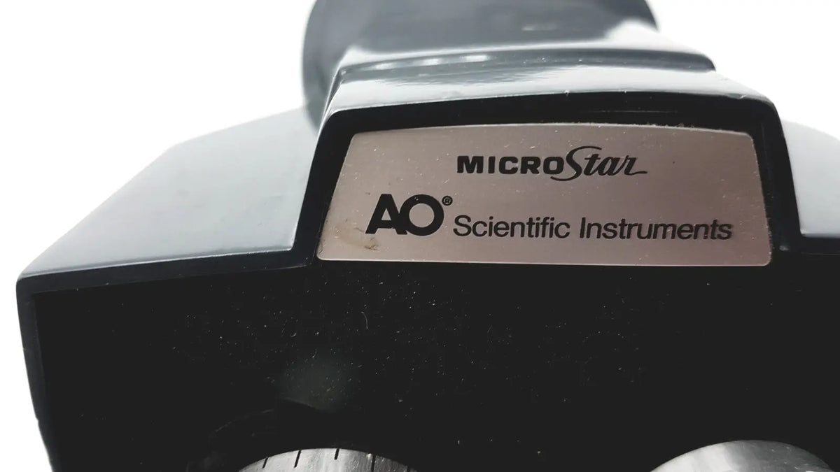 Black american optical microstar 110 120 binocular head microscope with ao scientific instruments metallic plate