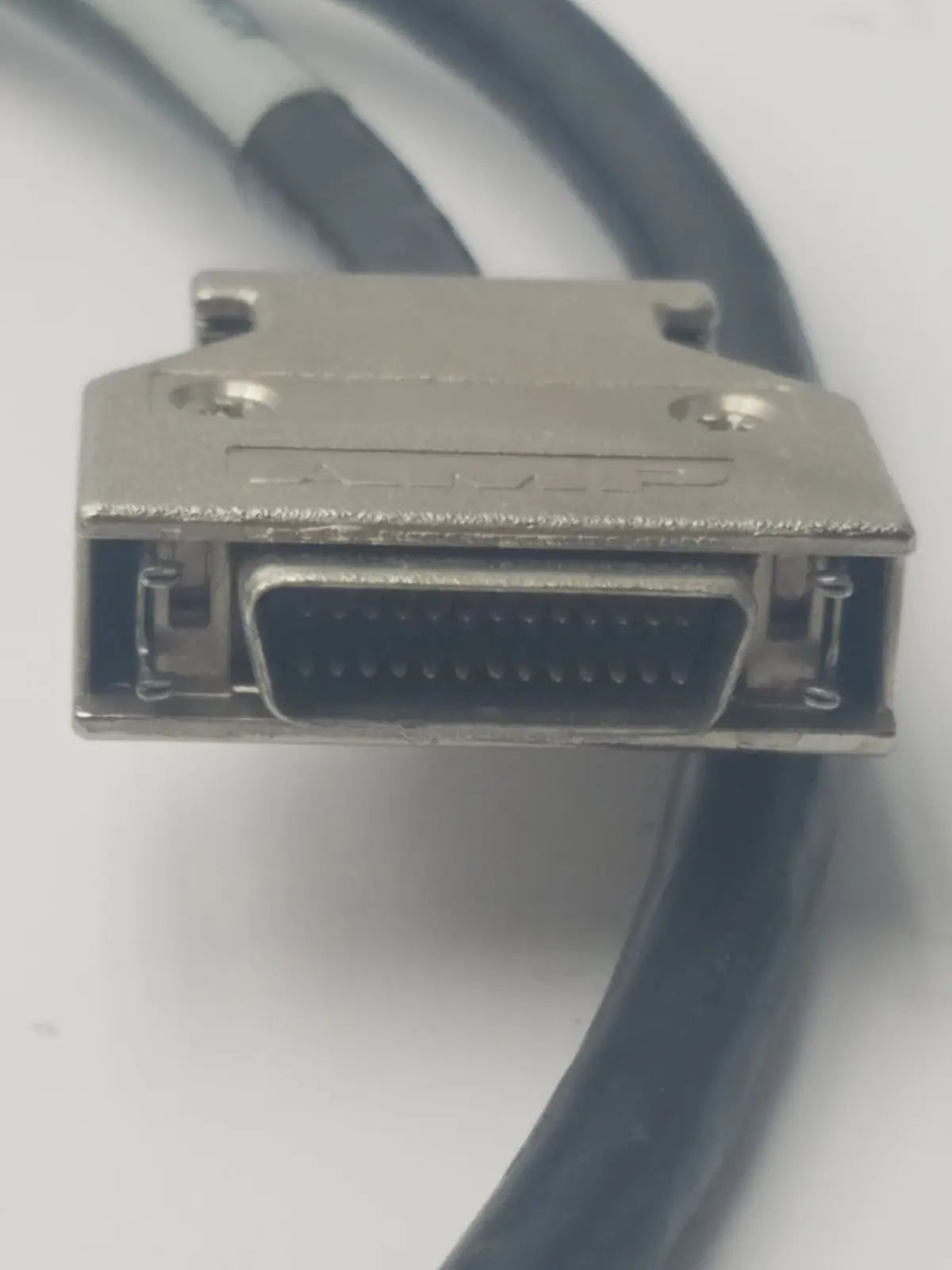 Silver-colored metal d-sub connector with black cable attached in amp scsi cable 26-pin vh dci to 26-pin male cable