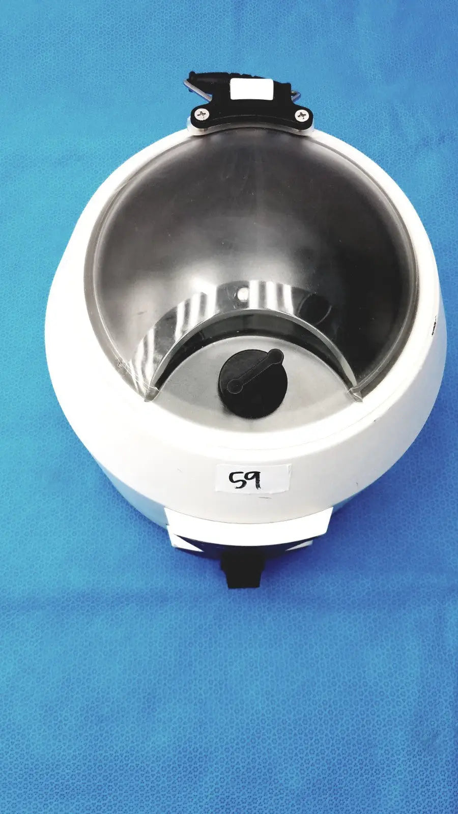 Ample Scientific Champion white circular electric waffle maker with stainless steel interior and black control knob