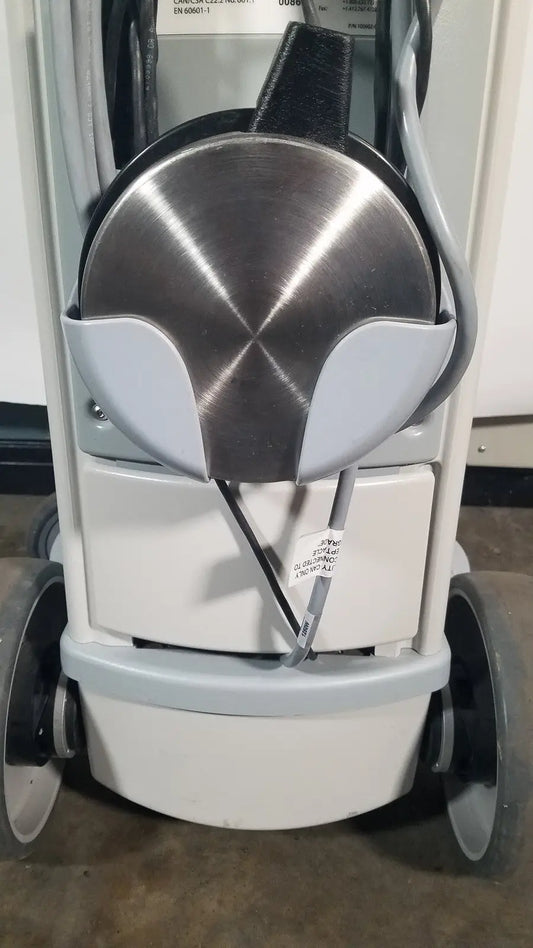 Silver metallic circular component with brushed finish housed in light gray casing of angiojet ultra thrombectomy system console 5000a