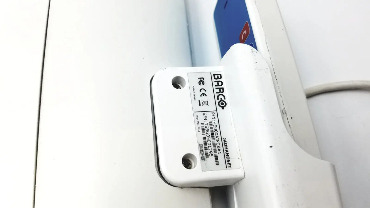 White plastic barco ja018 smart terminal electronic component label showing model and serial number for bedside multi-touch use