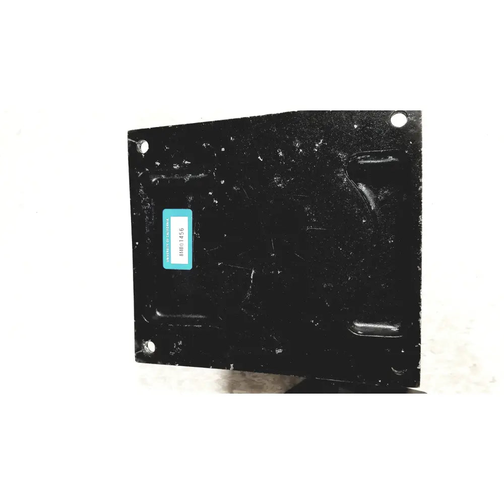 Black rectangular metal plate with teal label and four mounting holes on beckman coulter ultracentrifuge unit back side