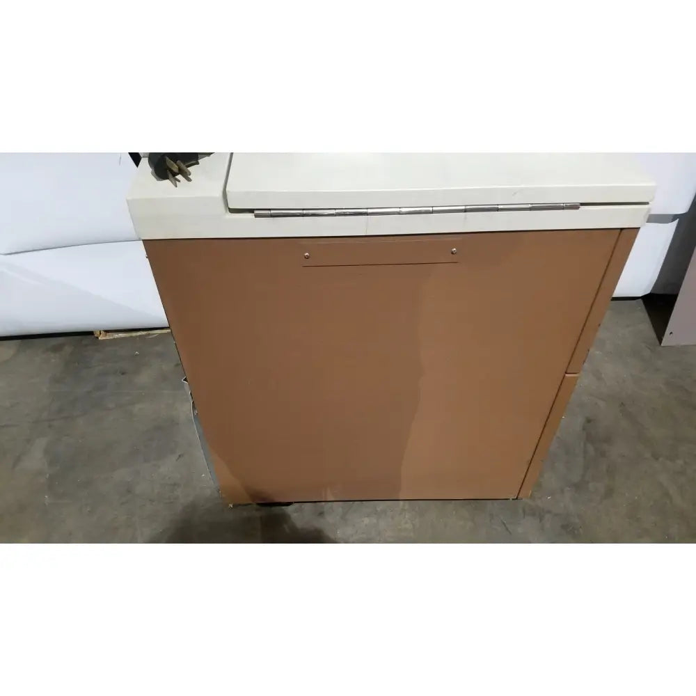 Tan metal cabinet with white top and silver hinge of beckman j2-21 refrigerated centriifuge for laboratory use