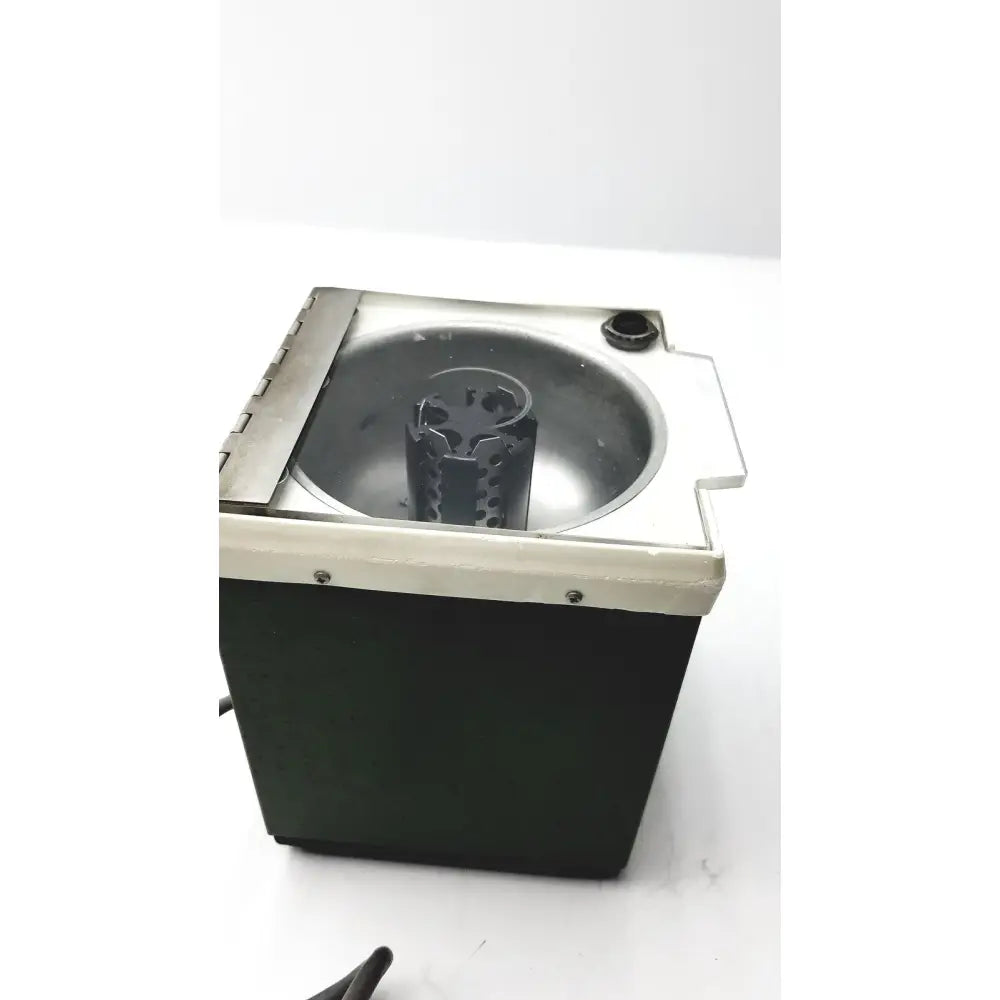 Black and silver electric hair dryer with circular heating chamber and adjustable nozzle shown with beckman microfuge 6-position rotor reuse medical product