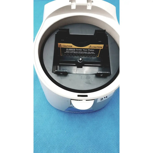 White plastic benchmark platefuge c2000 microplate microcentrifuge with black plate holder and yellow caution label inside