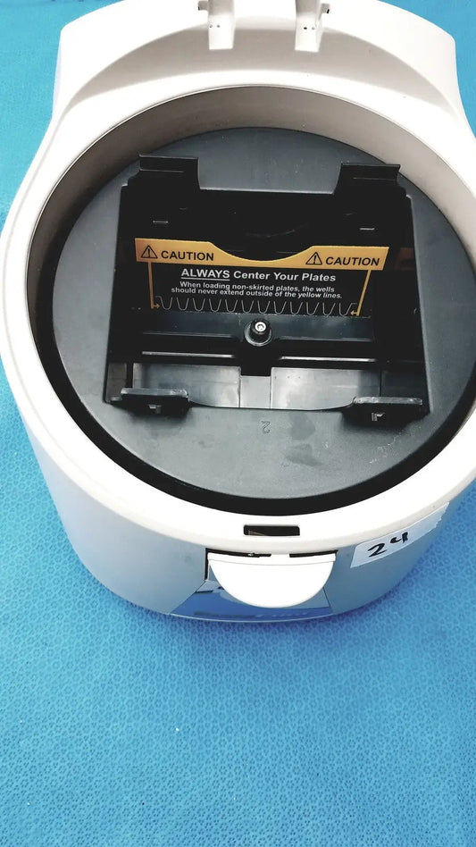 White plastic benchmark platefuge c2000 microplate microcentrifuge with black plate holder and yellow caution label inside