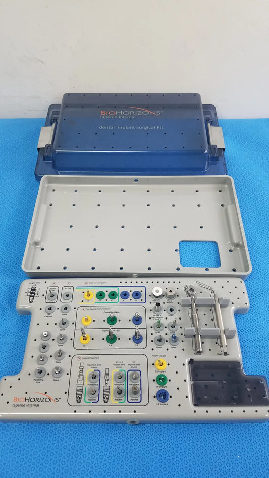 Bio horizons tapered internal dental implant surgical kit in blue and gray with organized trays holding colorful-handled tools