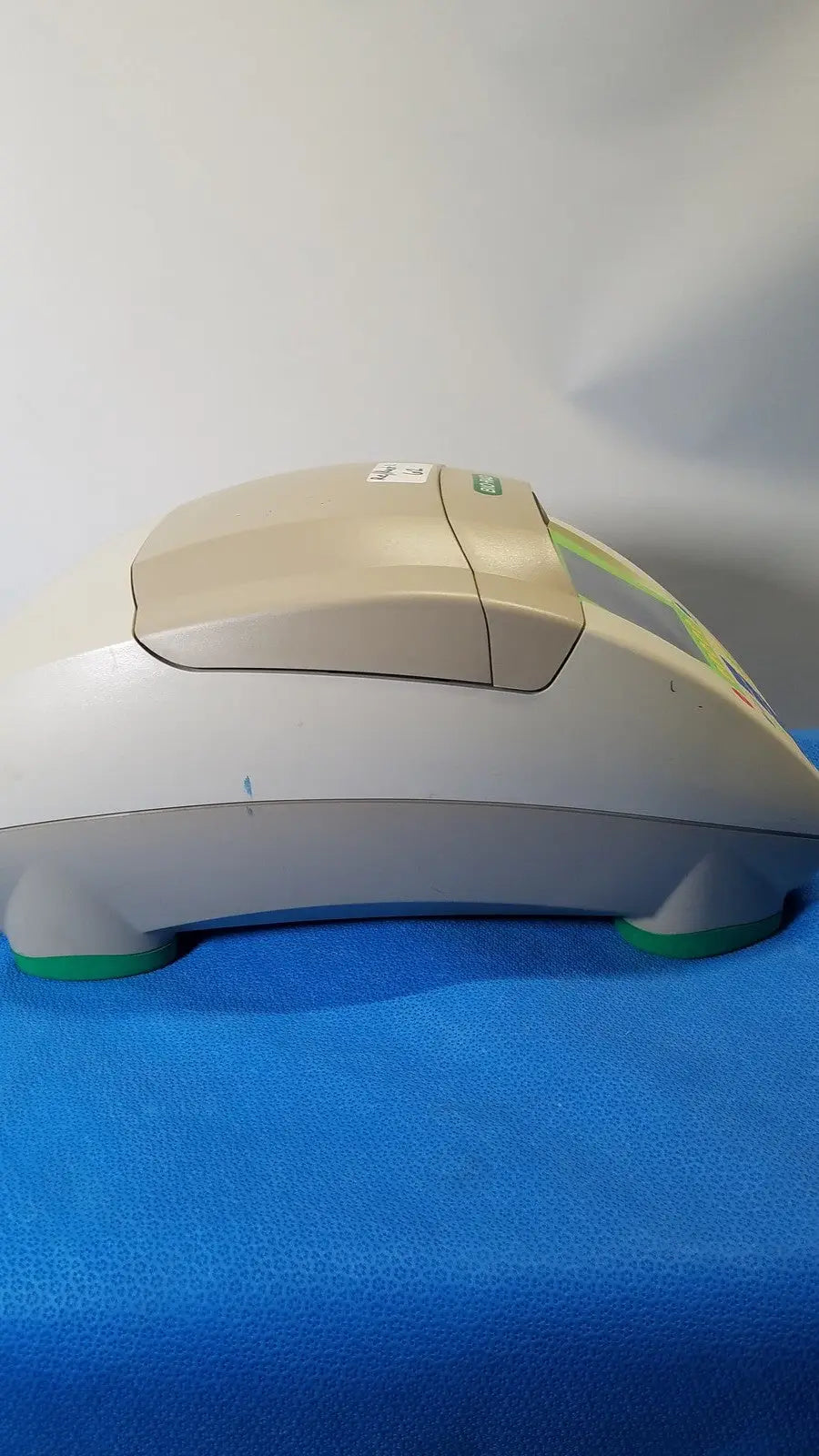 Beige and gray plastic bio-rad mycycler thermal cycler with green accents and sleek curved design for pcr applications