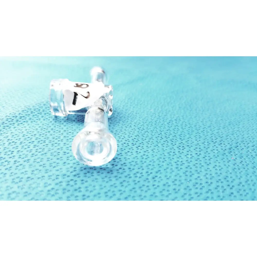 Clear plastic medical tubing with labeled connectors attached to a borosilicate glass stopcock adapter lab valve connector 24/40 joint