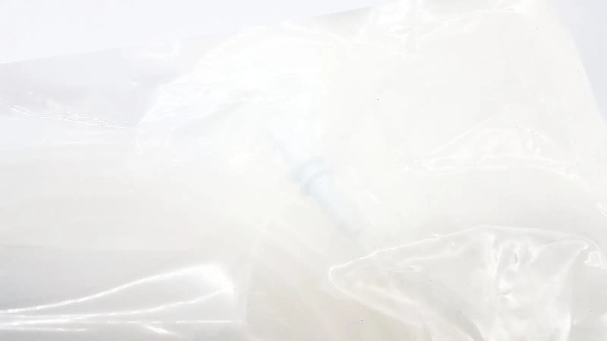 A translucent white plastic bag with crinkled texture and soft folds for boston scientific m0068402980 stone catcher
