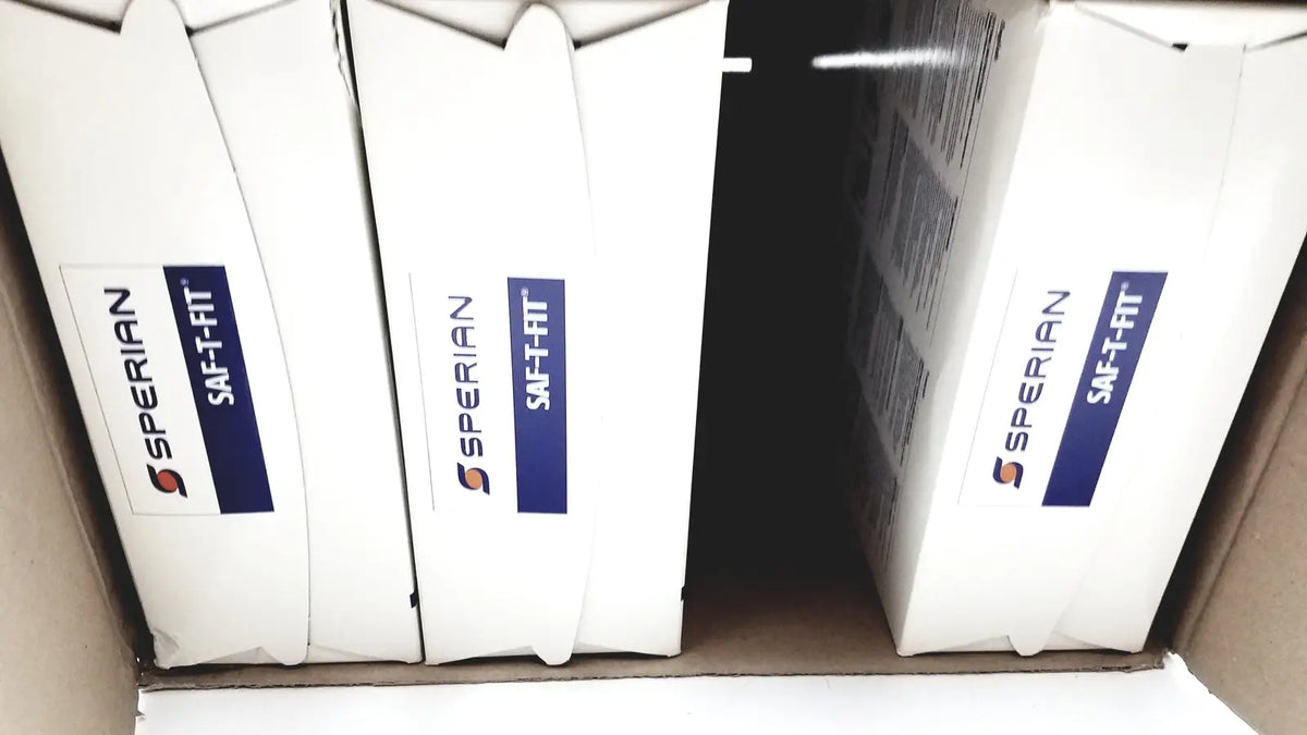 White cardboard boxes sperian saf-fit labeled for n9510f flat fold respirators with blue and orange logo