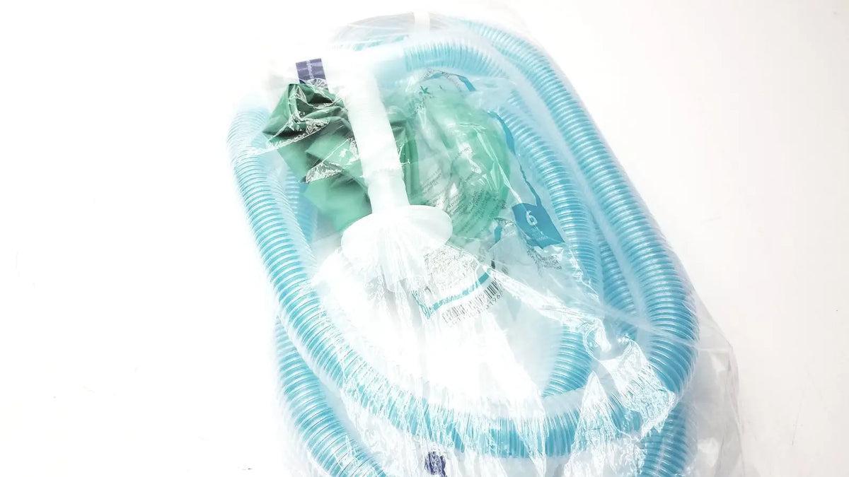 Breathing circuit with breathing bag coaxial featuring translucent blue corrugated tubing and white plastic connector in clear packaging