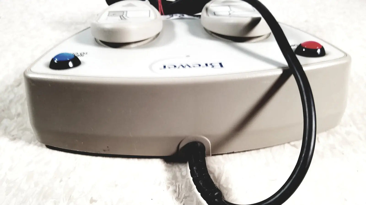 White plastic brewster high low power steam cleaner with two knobs and blue and red buttons for low power exam use