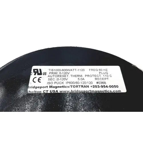 Black cylindrical electrical transformer with white label showing technical specs for bridgeport magnetics tis1000-600watt-1120
