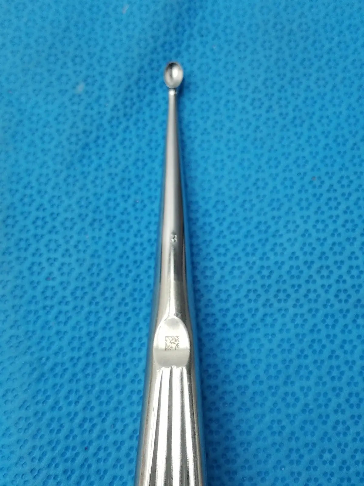 Stainless steel buggles spratt bone curette with a slender polished shaft and rounded tip for orthopedic use