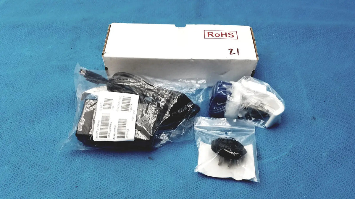 Black plastic power adapter with attached cable in clear bag for burton ultraviolet examining ultraviolet examining light