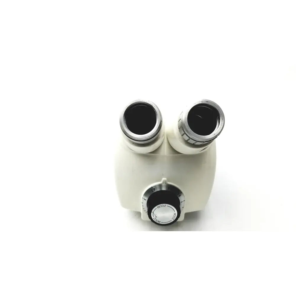 Cream-colored cambridge instruments stereozoom stereo microscope with dual eyepieces and black focus knob with markings