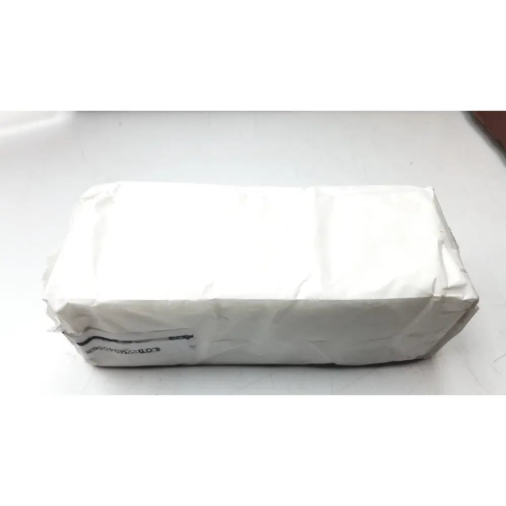 A rectangular white package of cardinal health curity sponges 2556g wrapped in crinkled paper with a black barcode label