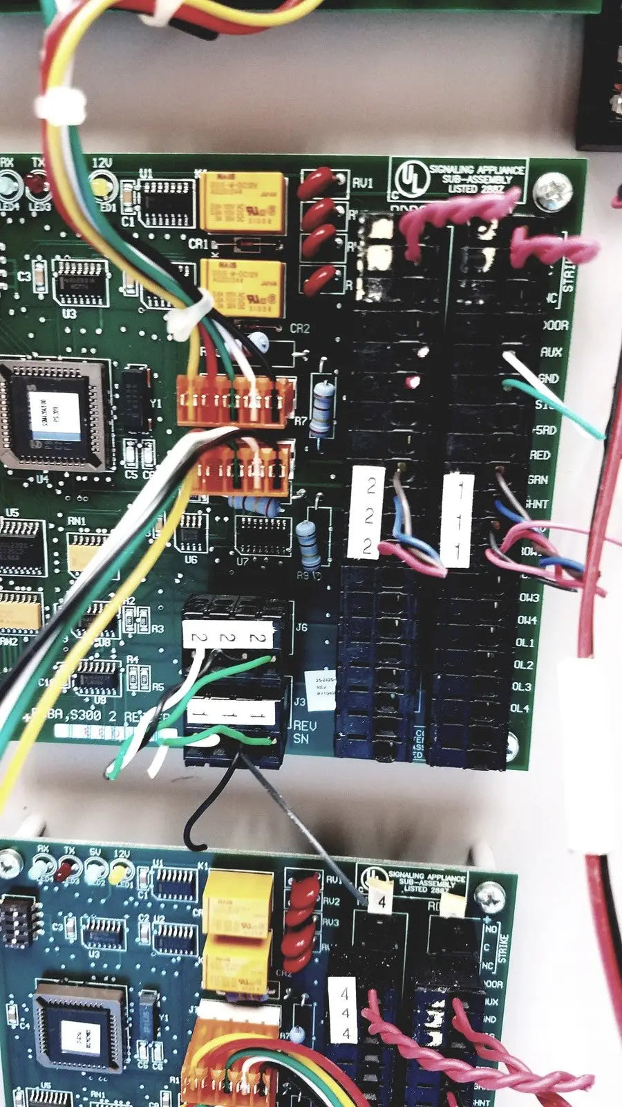 Green circuit board with electronic components and colorful wires for s300-xl access control panel controller