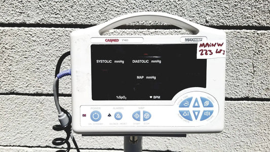 White casmed 740 vital signs monitor with sp02 finger probe black display and blue control buttons on rolling stand