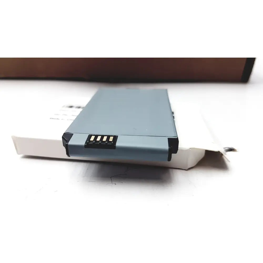 Gray rectangular phone accu battery with black contacts for cisco 7925 wireless ip phone extended use resting on white box