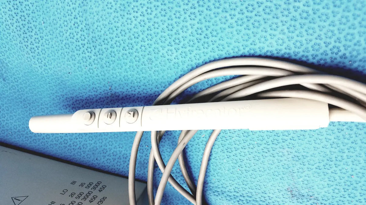 White plastic ecg electrode with three circular contact points and coiled gray cable for conmed model 2000 high frequency equipment