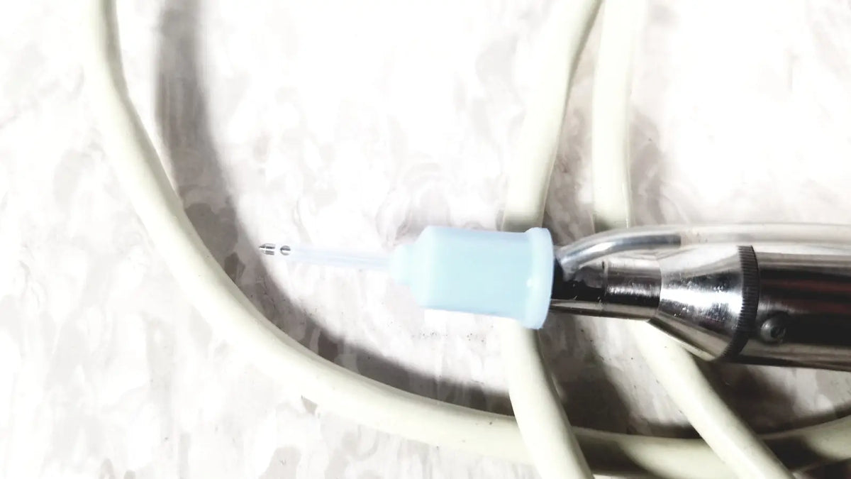 Cooper Vision 390 unipak handpiece with metallic body, light blue tip, and black grip for Alcon phacoemulsifier with case