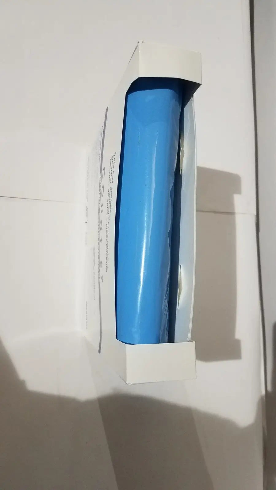 A vibrant blue glossy plastic roll of adhesive tape inside a white box for count ez sponge surgical count bags