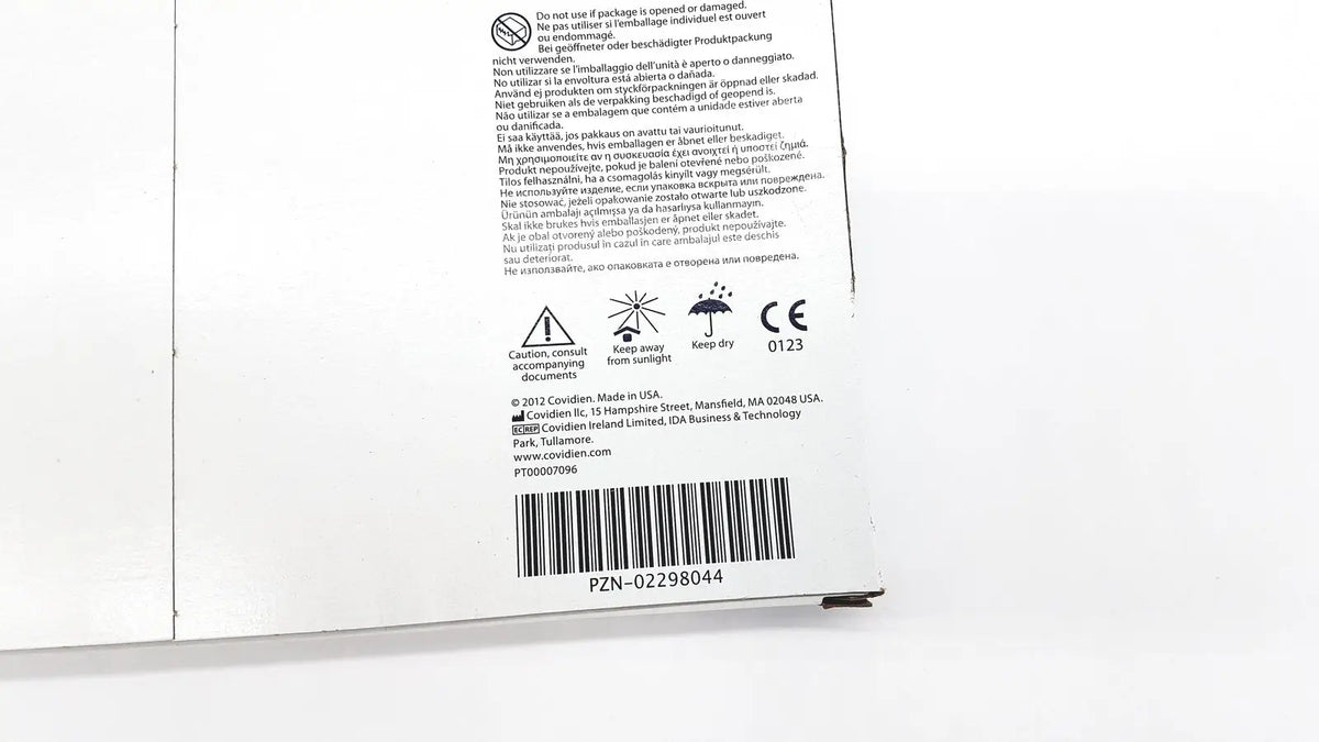 White cardboard packaging backside of covidien 6648kendall transparent film dressing with multilingual safety warnings and barcode