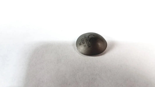 Dark gray circular metal cox ii ocular laser eye shield without handle with engraved markings for surgical use