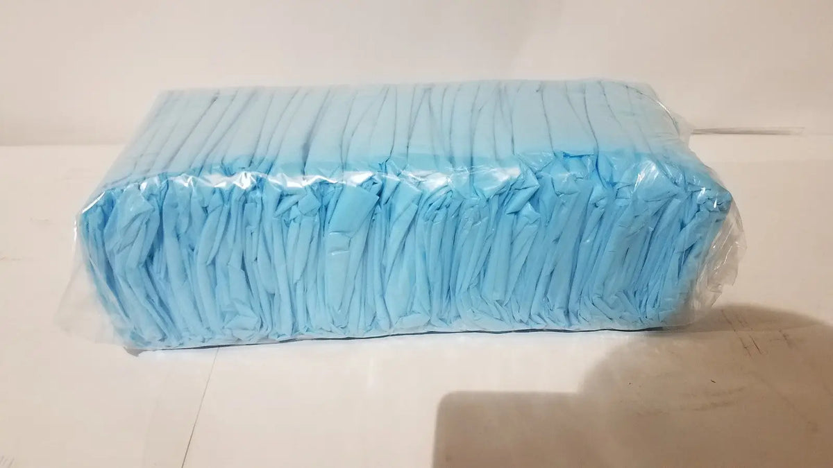 A rectangular package of light blue disposable diapers wrapped in clear plastic unrelated to cpe isolation gown product